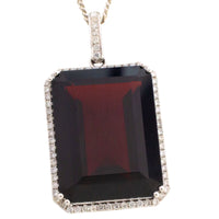 Garnet and diamond pendant in white gold